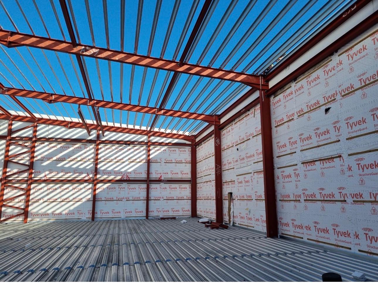 Steel-framed modular unit interior with insulated wall panels installed