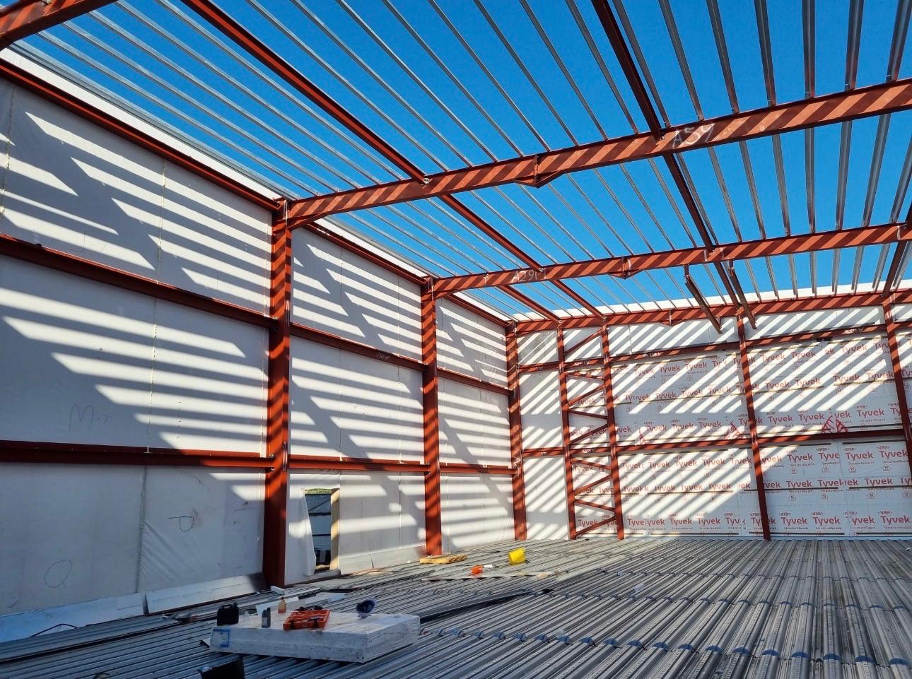 Modular building steel frame with roof structure and clad walls under construction