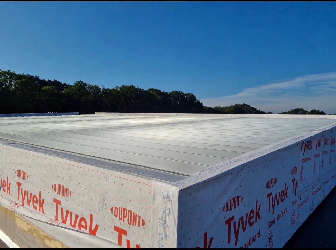 Roof view across installed modular units on a completed volumetric building